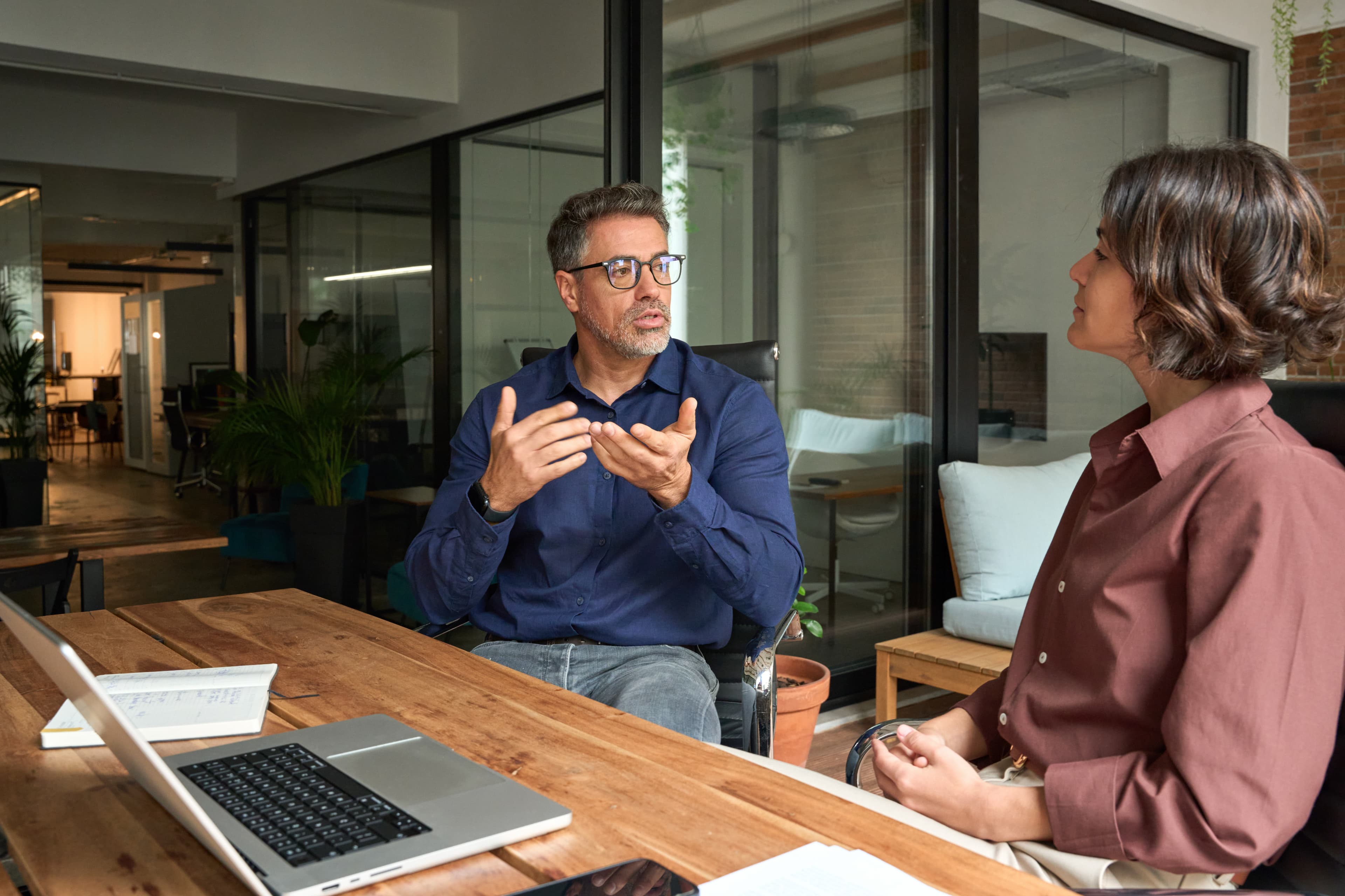 Man talking across a table during a one-on-one meeting.